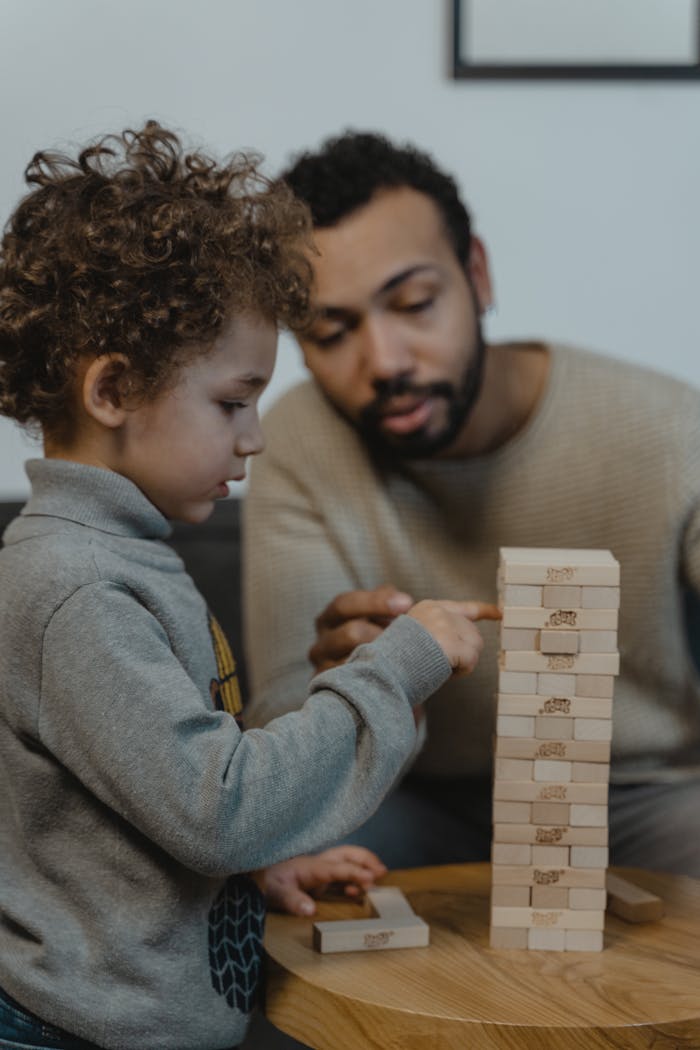 services-03 Father and son enjoying a game of Jenga together, enhancing bonding time.